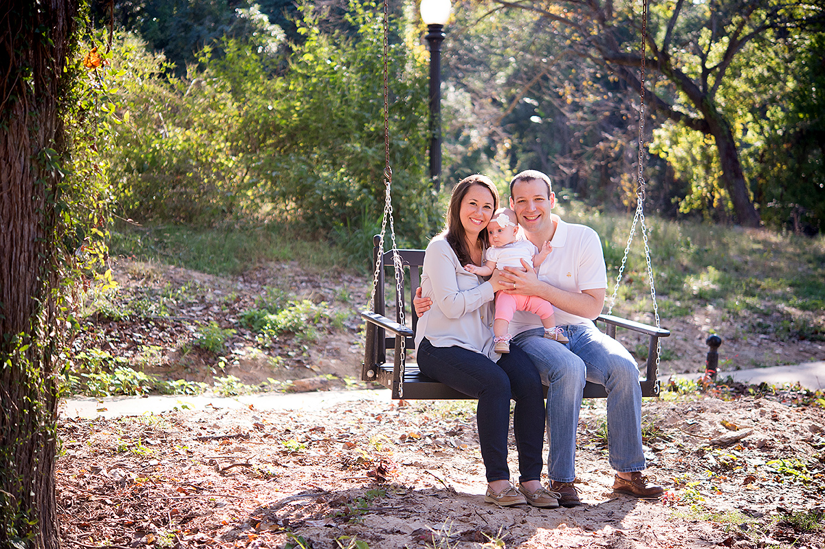 mom dad baby on swing