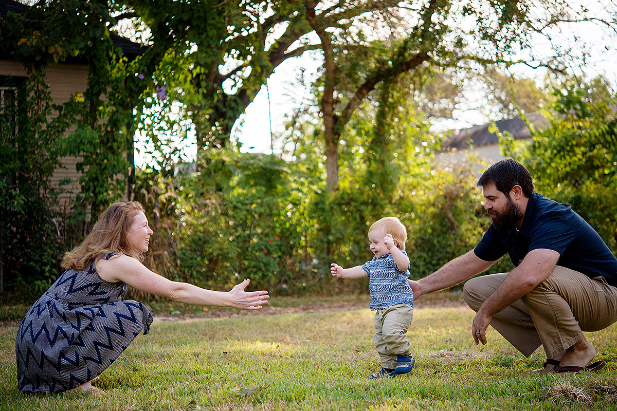 baby walking to parents for pictures